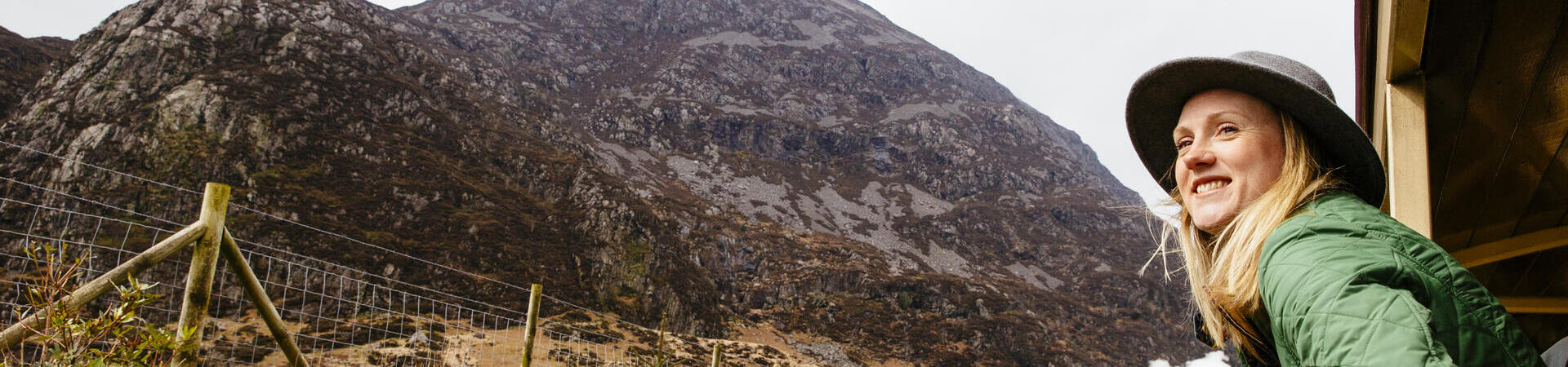 Woman leaning out of window of steam train
