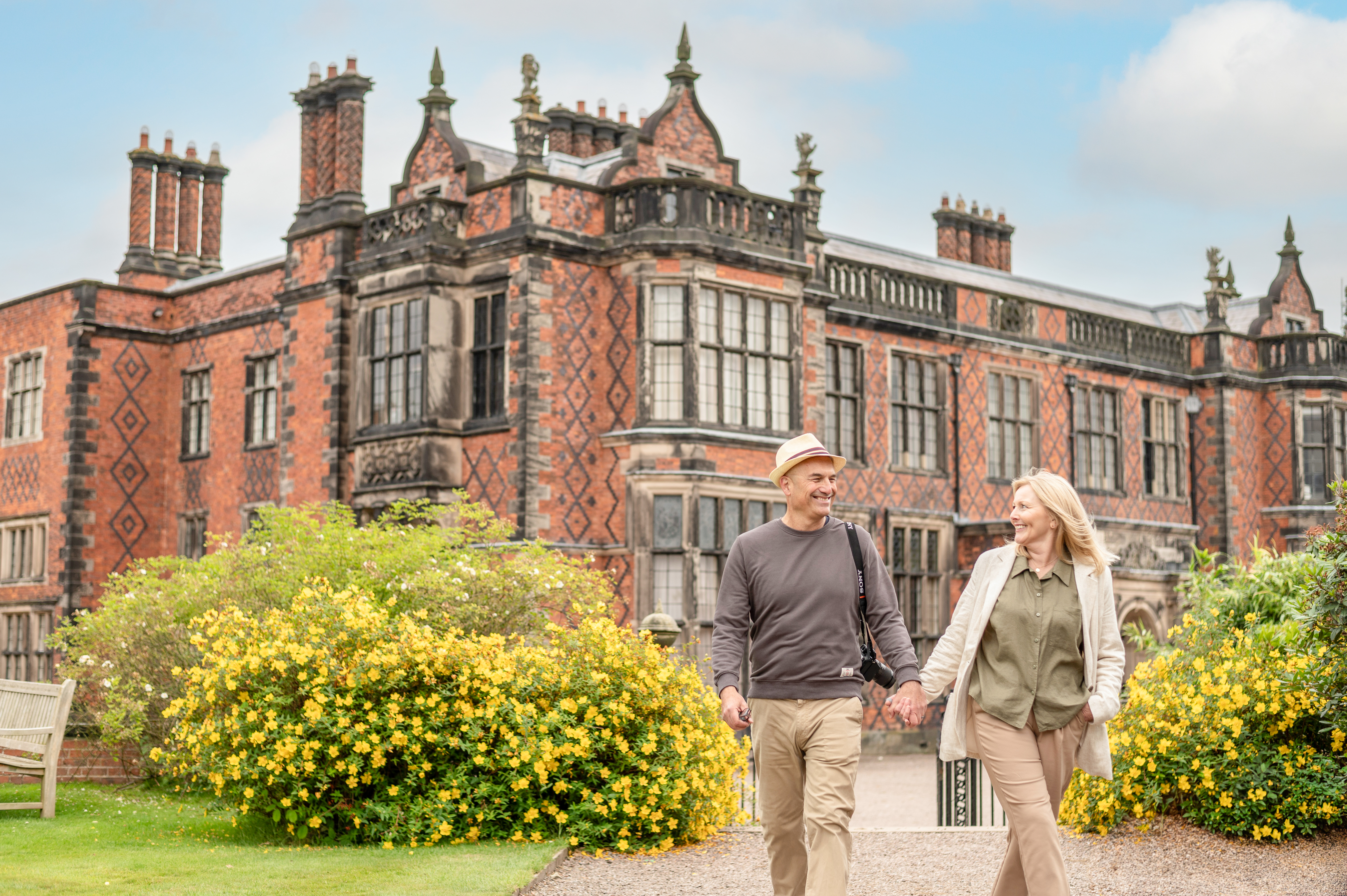 A man and a woman walk through the grounds of a heritage property