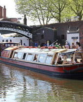 Ein Lastkahn fährt auf einem Kanal in Birmingham in der Nähe von Sherborne Wharf