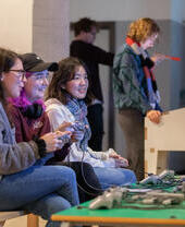 A group of people playing a video game together at the National Video Games Museum in Sheffield