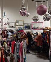Groups of people searching through clothing at the Green Heart Collective in Grainger Market, Newcastle