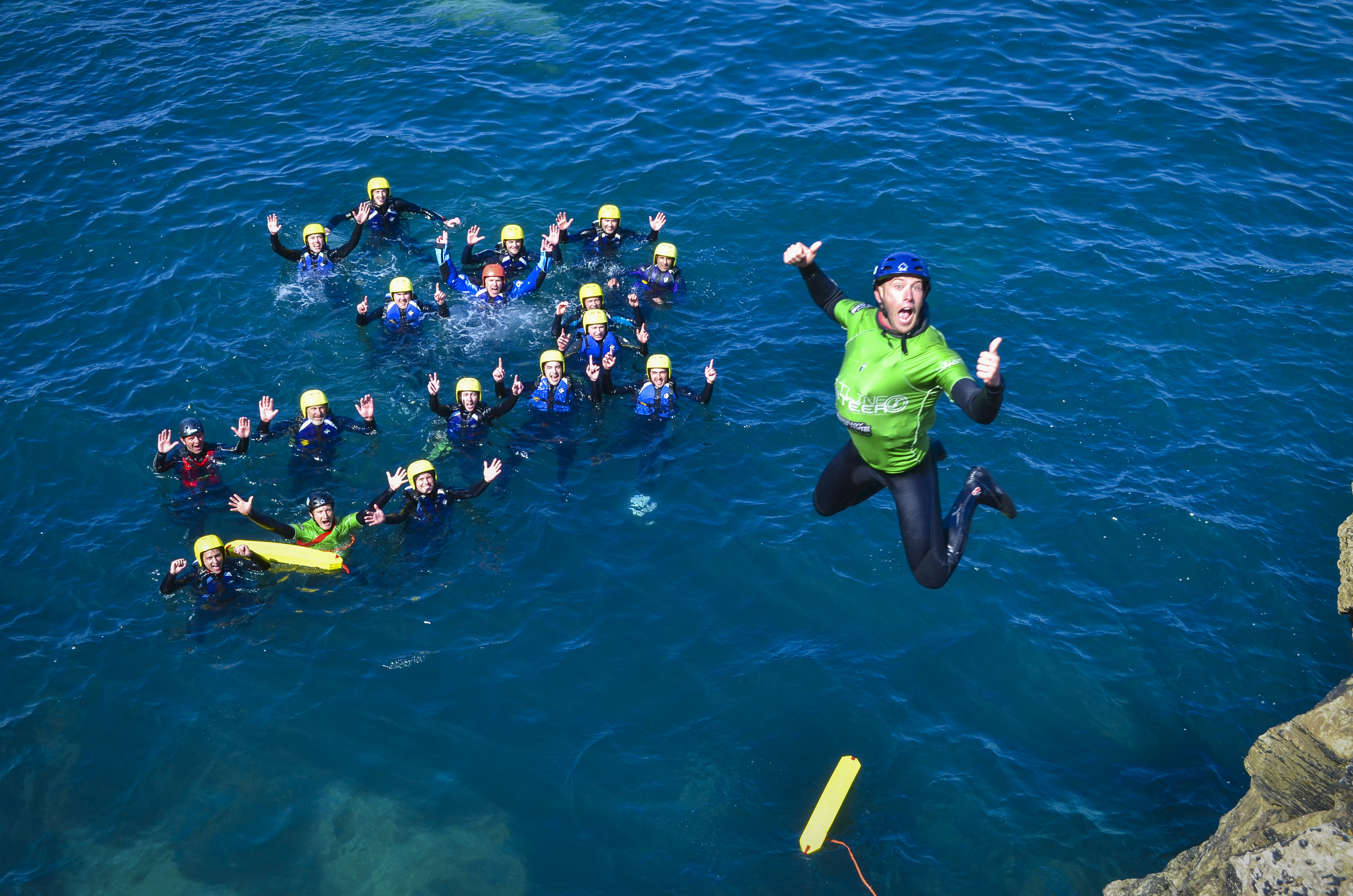 A man diving into the sea off the coast of Cornwall