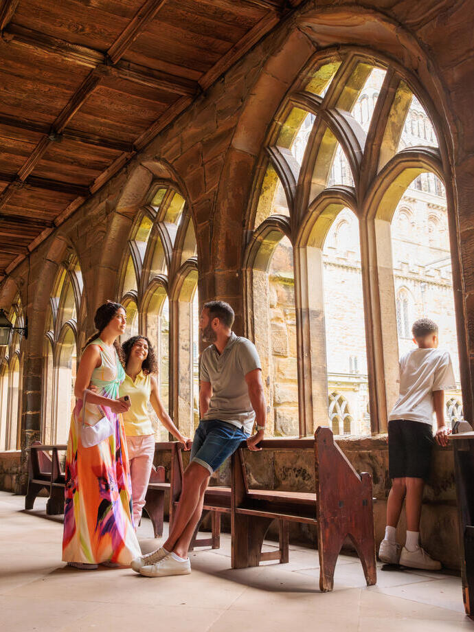 A family share a moment inside the cloisters of a cathedral