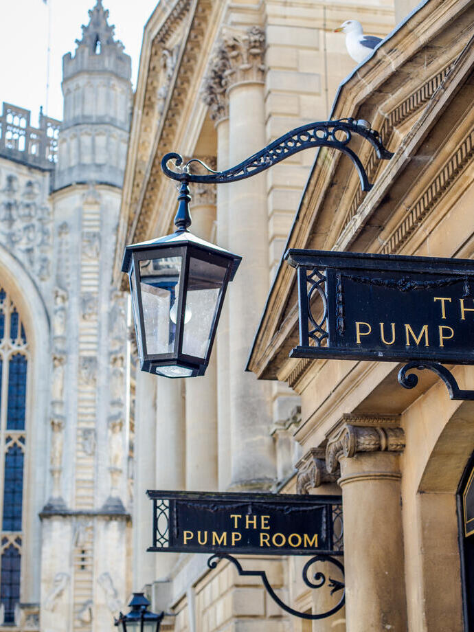 A view of the entrance to The Pump Room with a church in the background at an elegant upmarket restaurant.