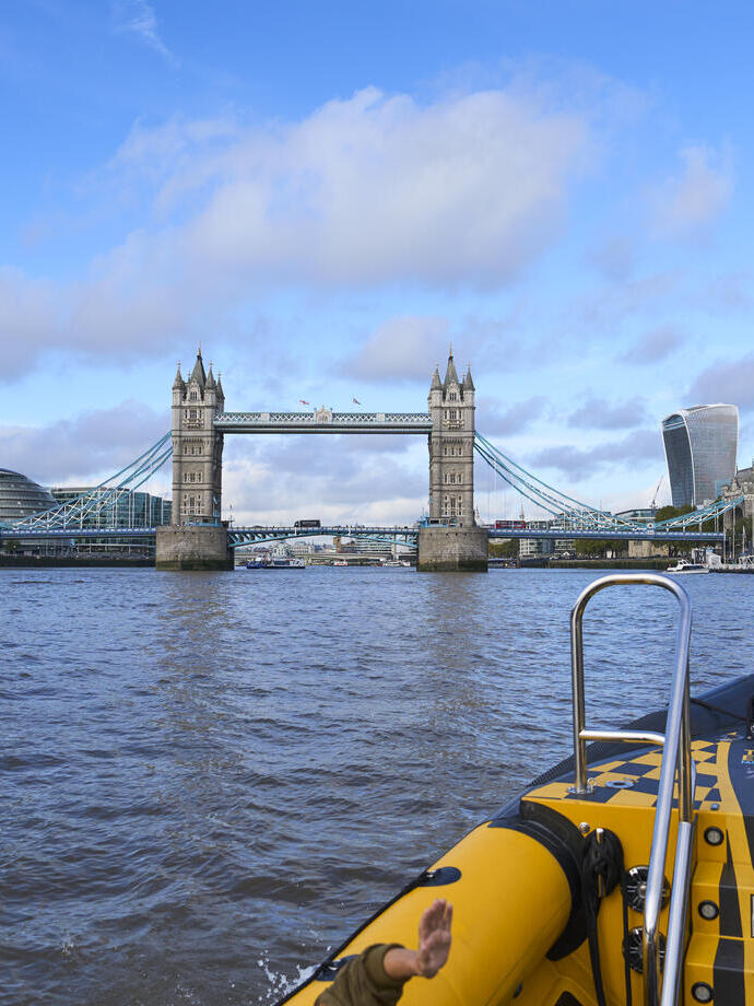 Group of people on board a speed boat on a city river