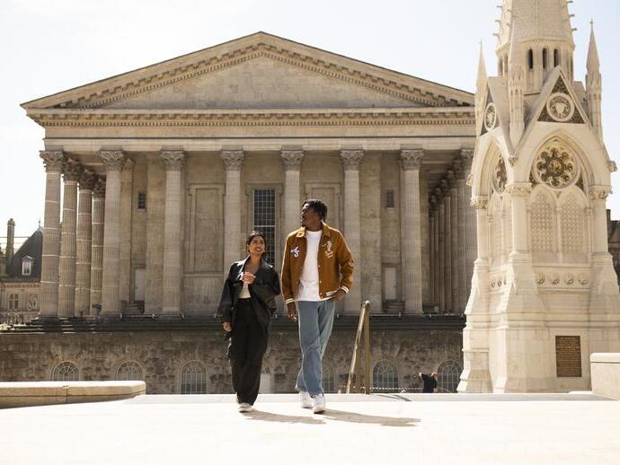 A couple strolling through an ornate English Town Square