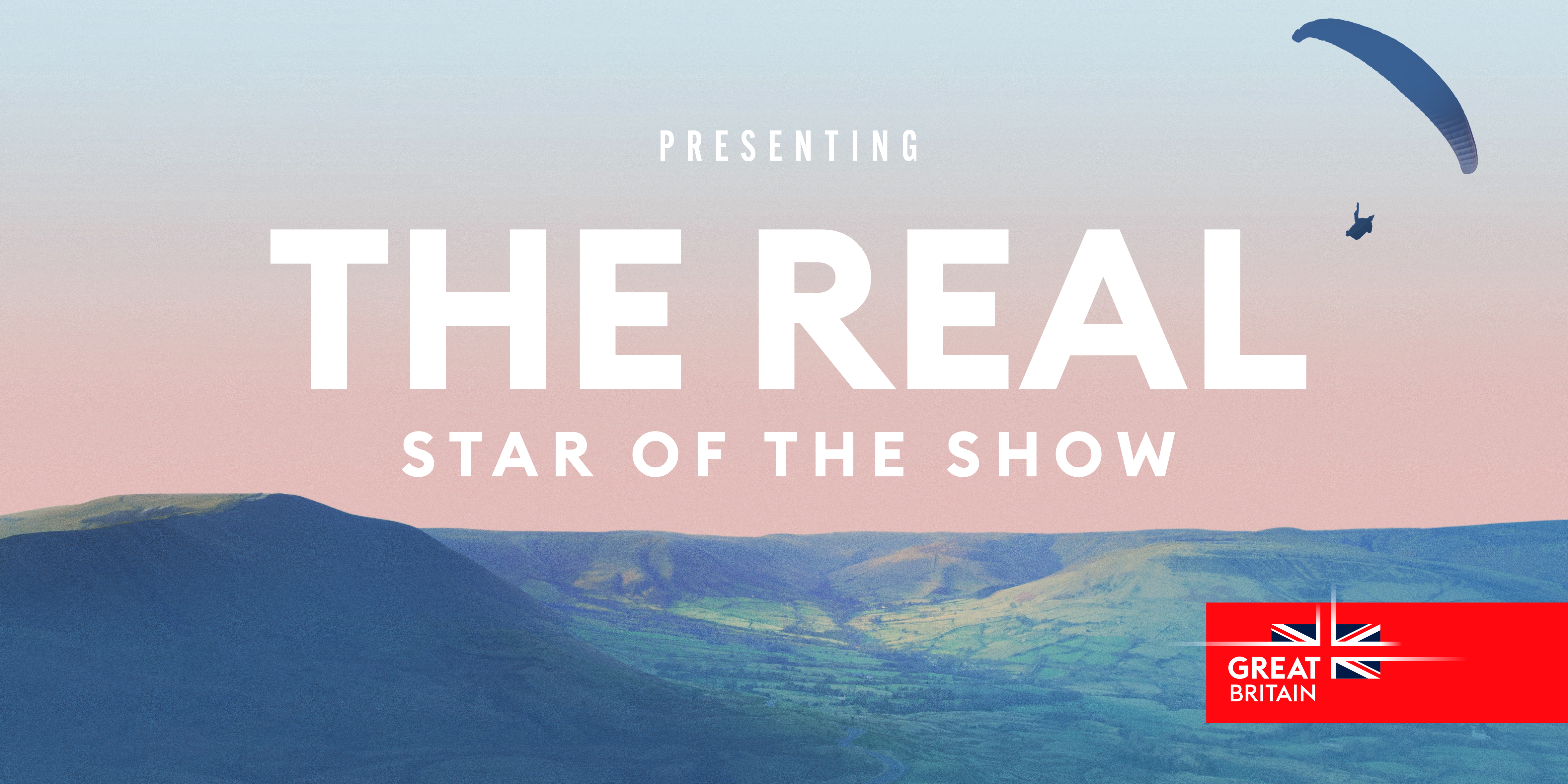 A cinematic destination ad featuring a paraglider soaring over hills in Great Britain.