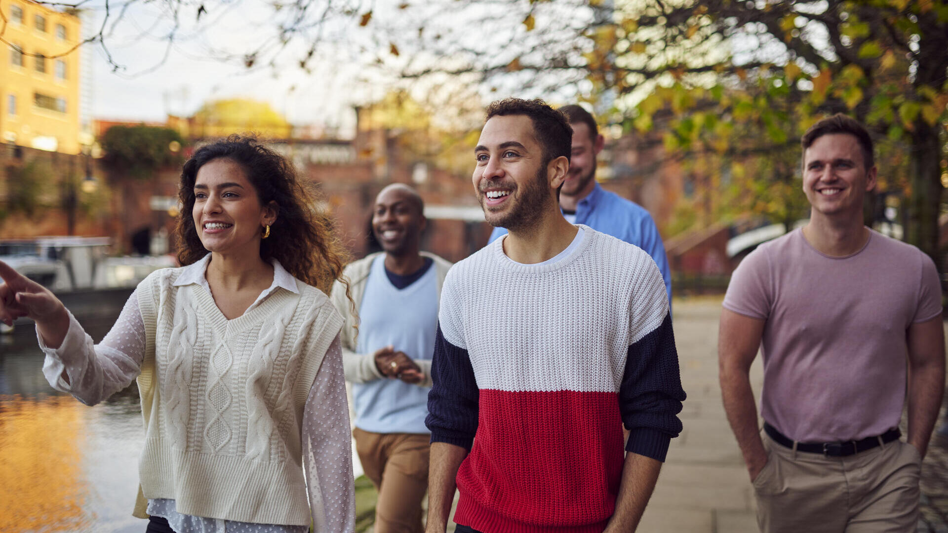 Friends walking by a canal