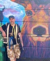 A tour guide highlighting Brighton's graffitti art on a tour