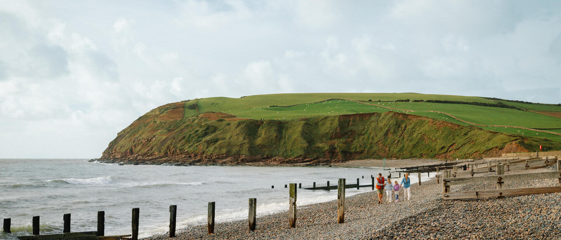 Family walking along a beach
