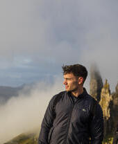 زوجان يقفان بالقرب من قمم البازلت، يشاهدان الضباب