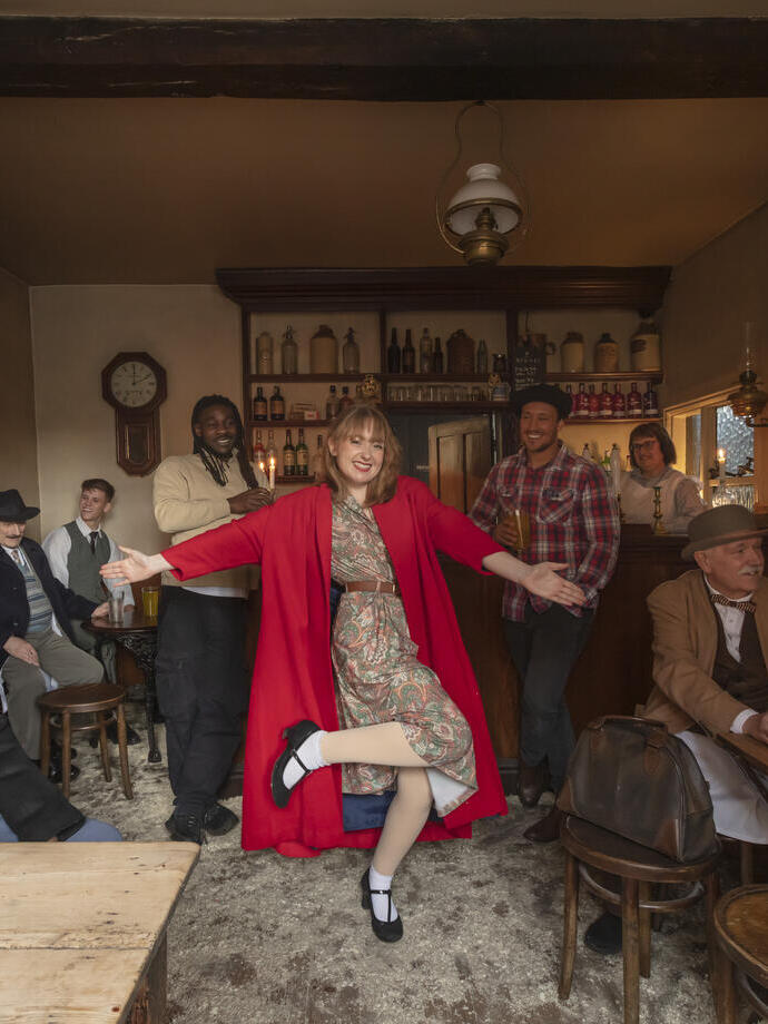 Actors in old style 1940's clothing enjoying a night back in time in a 1940's pub