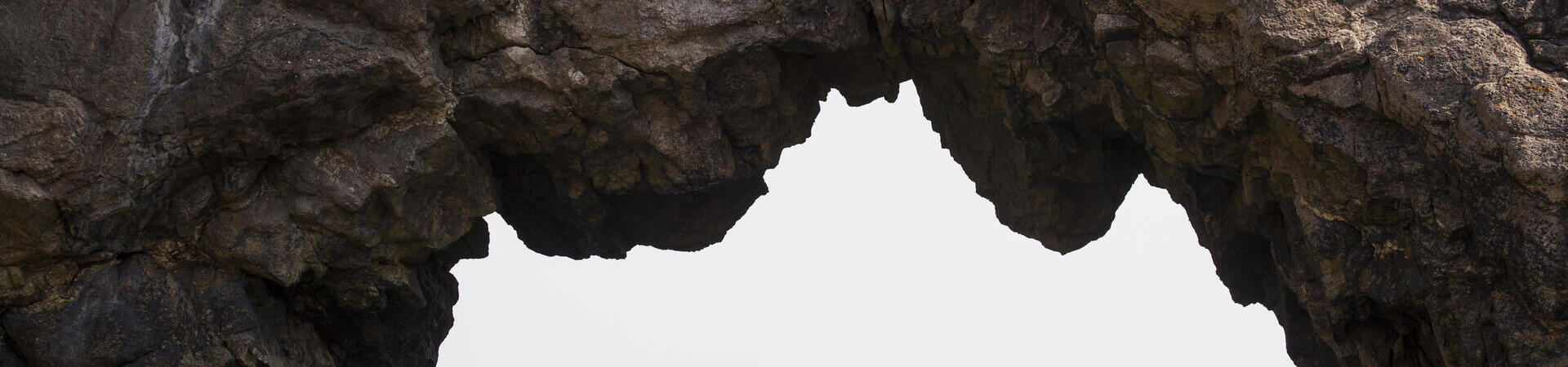 People kayaking under limestone cliffs