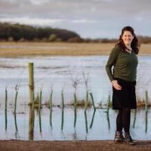 Lucy Downing standing near a lake