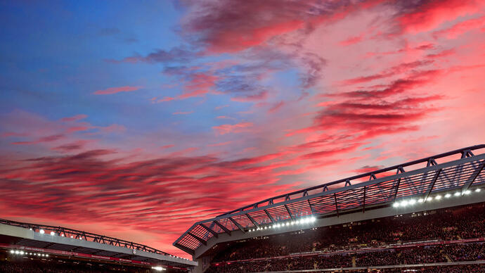 Nubes rojas al atardecer sobre el terreno de un estadio