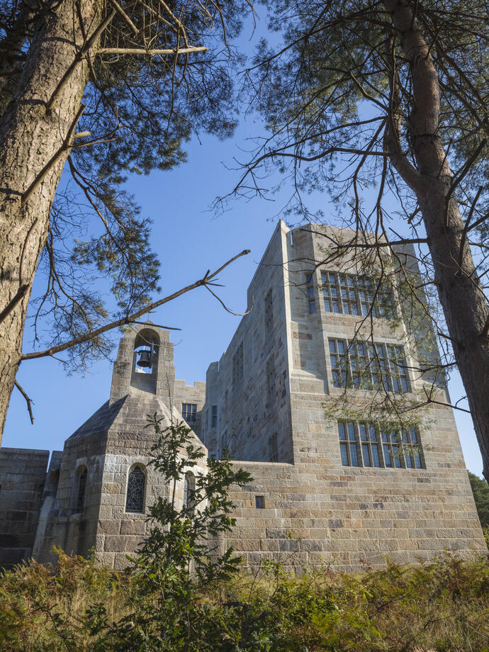 Exterior of Castle Drogo, looking up through the fir trees