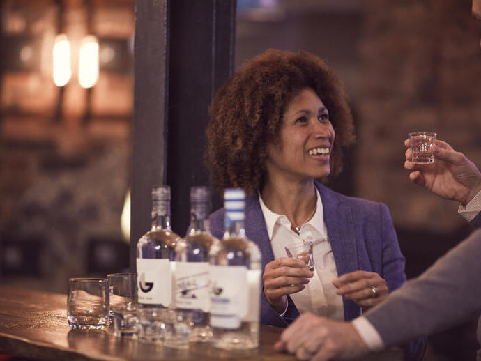 Una coppia che degusta whisky con tre bottiglie davanti a sé