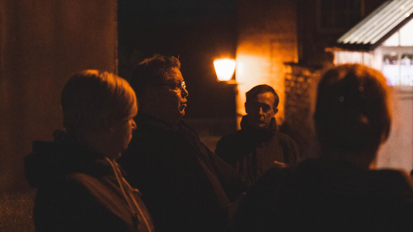 A tour group on a ghost walk at night in Lincoln