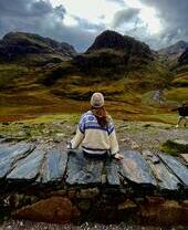 Una mujer sentada en el campo en otoño.