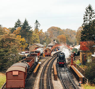 Steam train leaving a train station