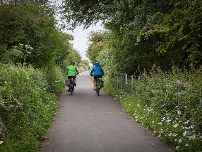 People cycling through the countryside