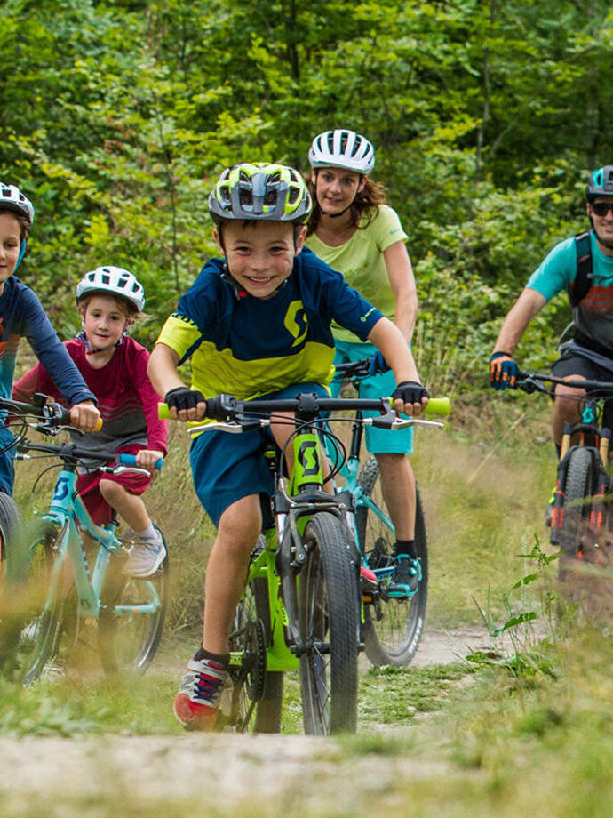 A group of children and parents cycling through the Leicestershire countryside