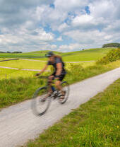 Two cyclists on a trail in the countryside