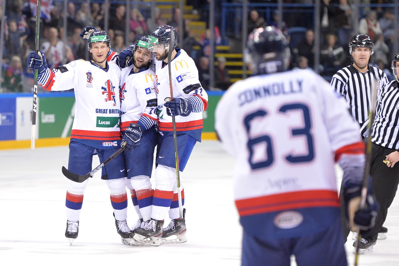 Men celebrating after scoring at ice hockey game