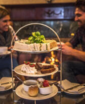 Couple having afternoon tea in a hotel