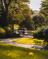 A fountain surrounded by trees in Lincoln Arboretum