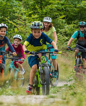 A group of children and parents cycling through the Leicestershire countryside