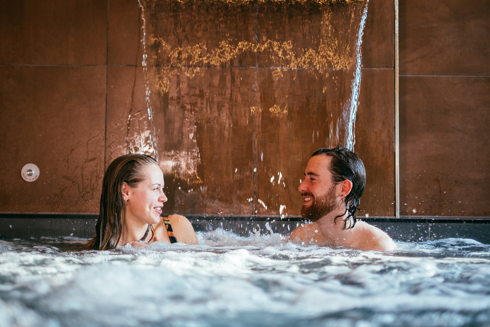 A couple in a pool as part of a spa treatment at Wave Garden Spa