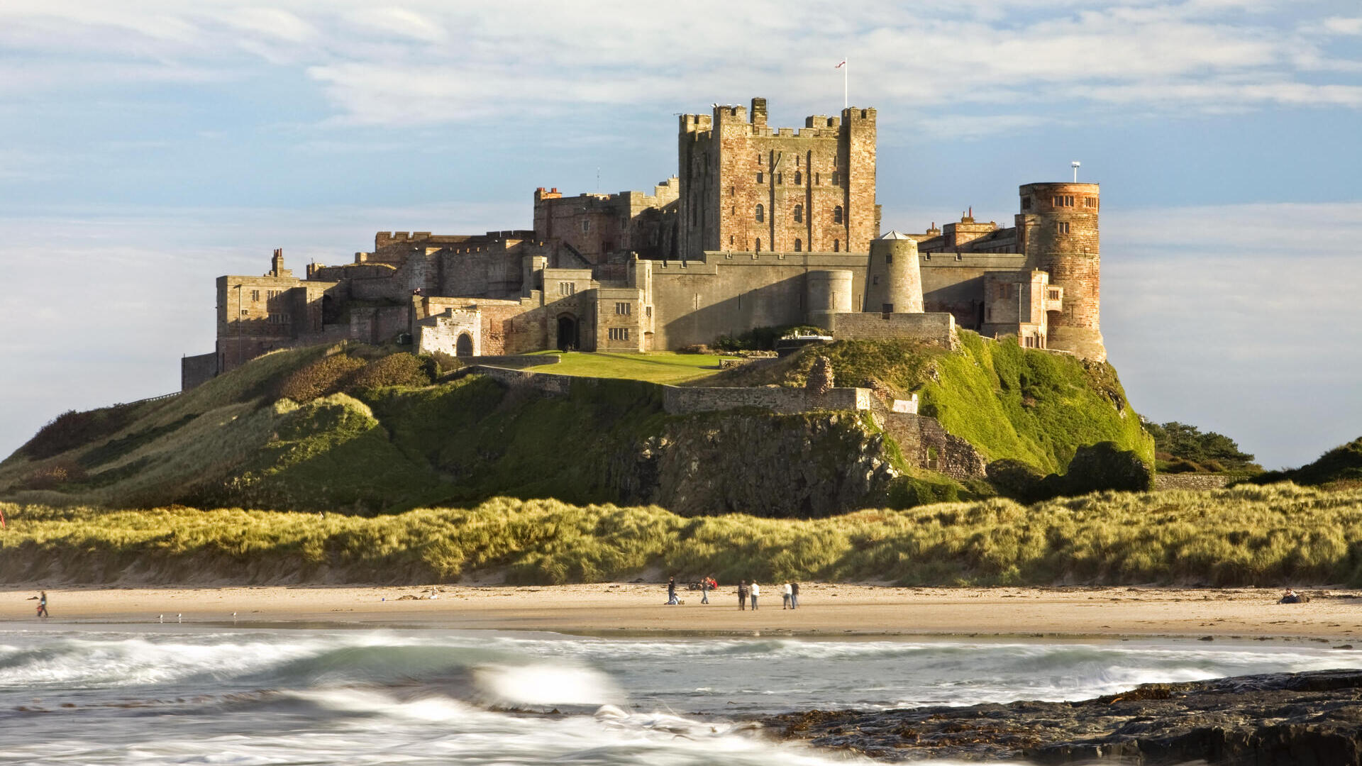 A castle on a cliff by a beach