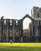 Visitors walking in the garden at Fountains Abbey and Studley Royal Water Garden, North Yorkshire