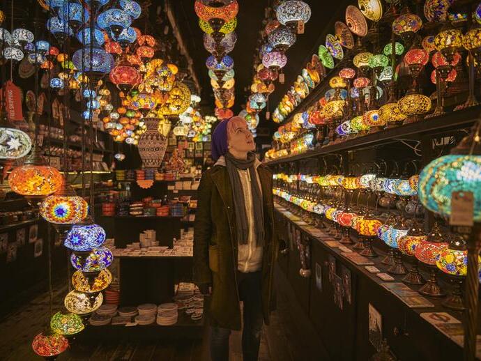 One young woman standing in a lighting shop