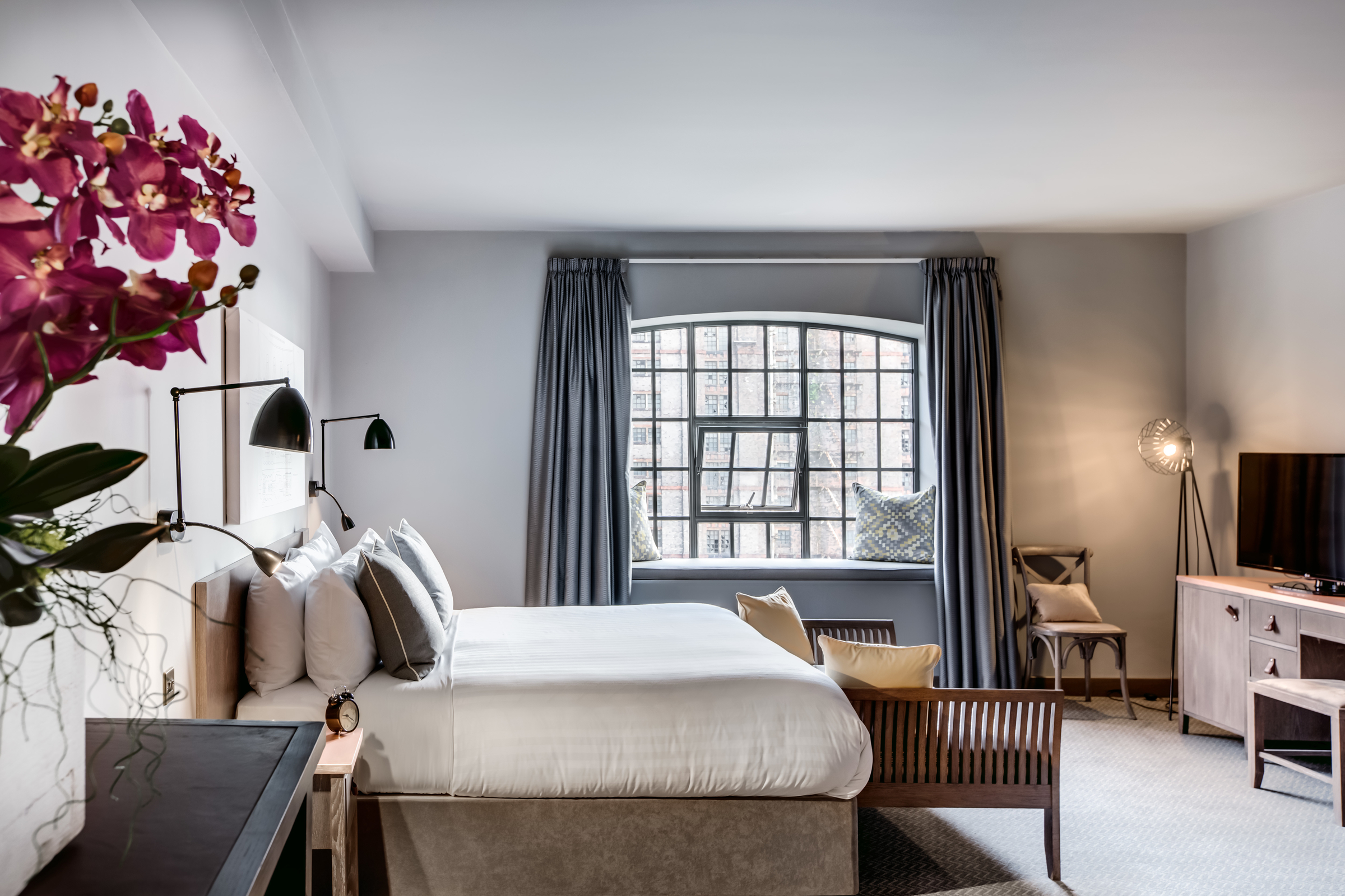 A luxury hotel room with double bed.