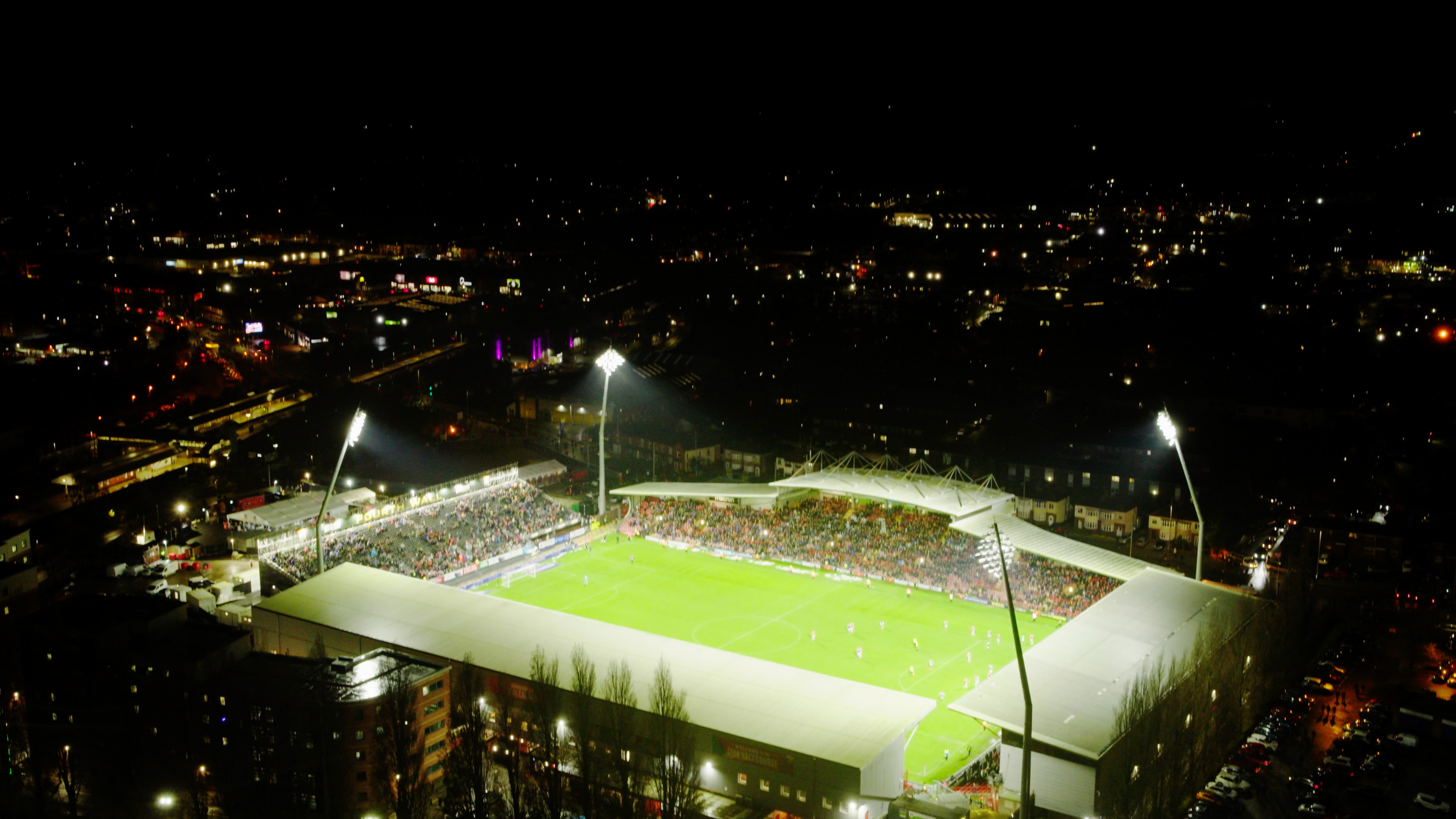 Un estadio de fútbol abarrotado por la noche.