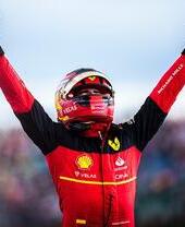 Car racer lifting his arms up in the air