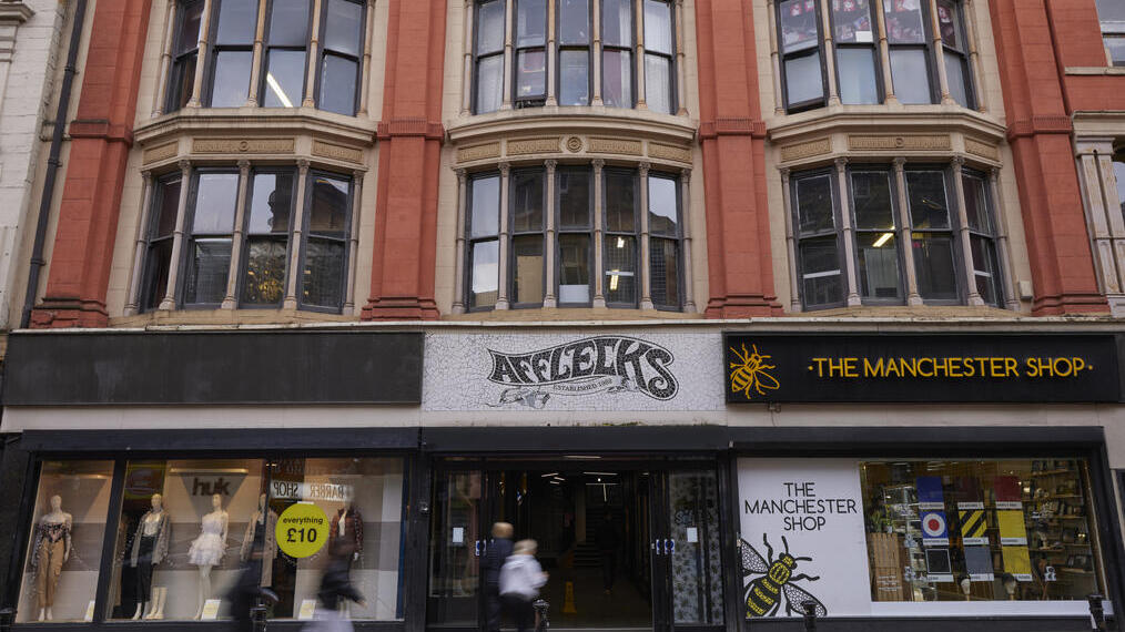 The exterior of Afflecks and The Manchester Shop with people walking past on the pavement in Manchester city centre.