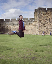 Woman on a broomstick outside a castle