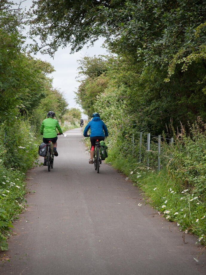 People cycling through the countryside
