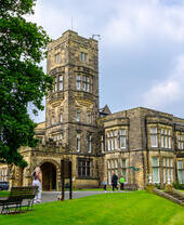 Family walking around the grounds of Cliffe Castle Museum, Bradford.