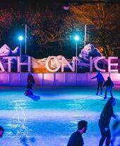 Iceskaters gliding across the ice in the evening at Bath on Ice