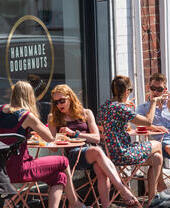 Groups of people sitting outside Handmade Doughnuts in Sheffield