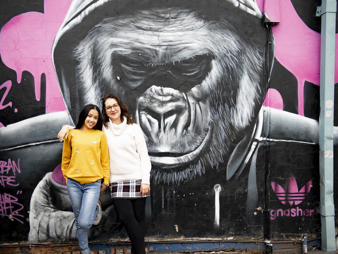 two people stand in front of Gorilla artwork by Gnasher