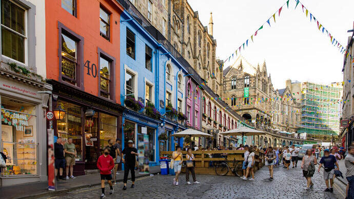 People walking in a street in a city lined with shops