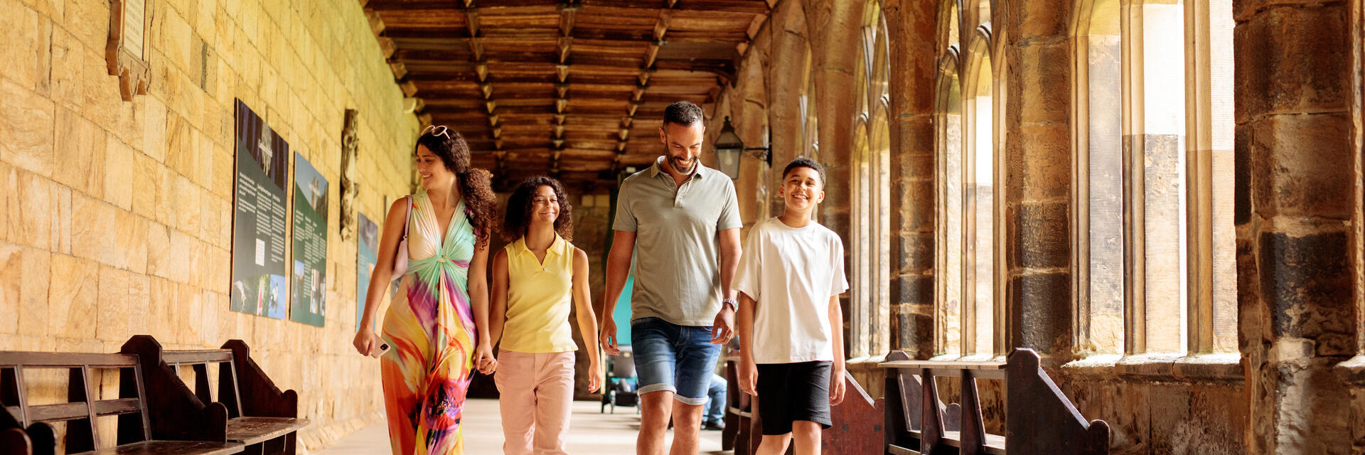 Family walking through the cloisters of a cathedral