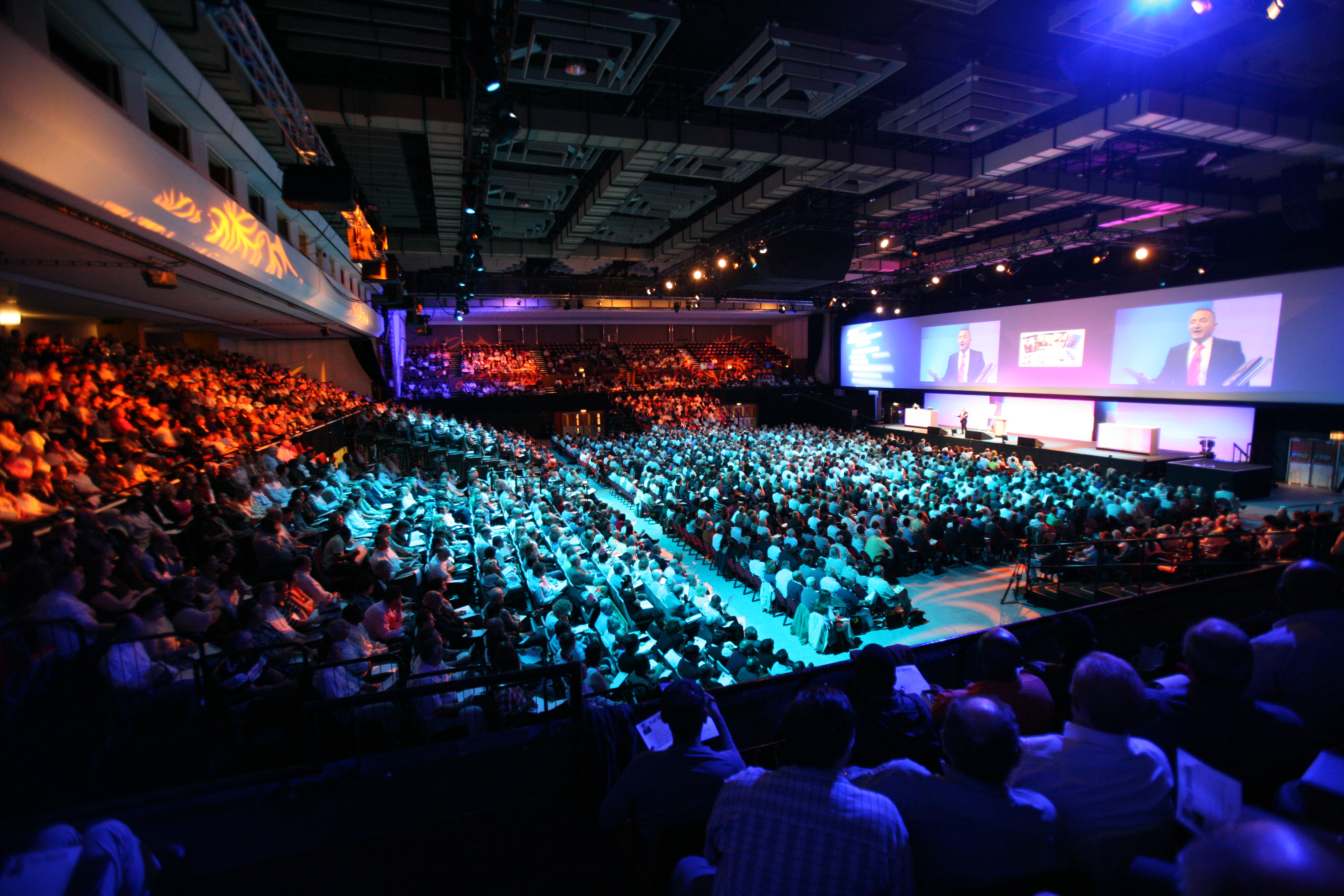 Group of people sitting in an auditorium during a presentation
