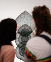 Two people looking at an art exhibit in Modern Art Oxford