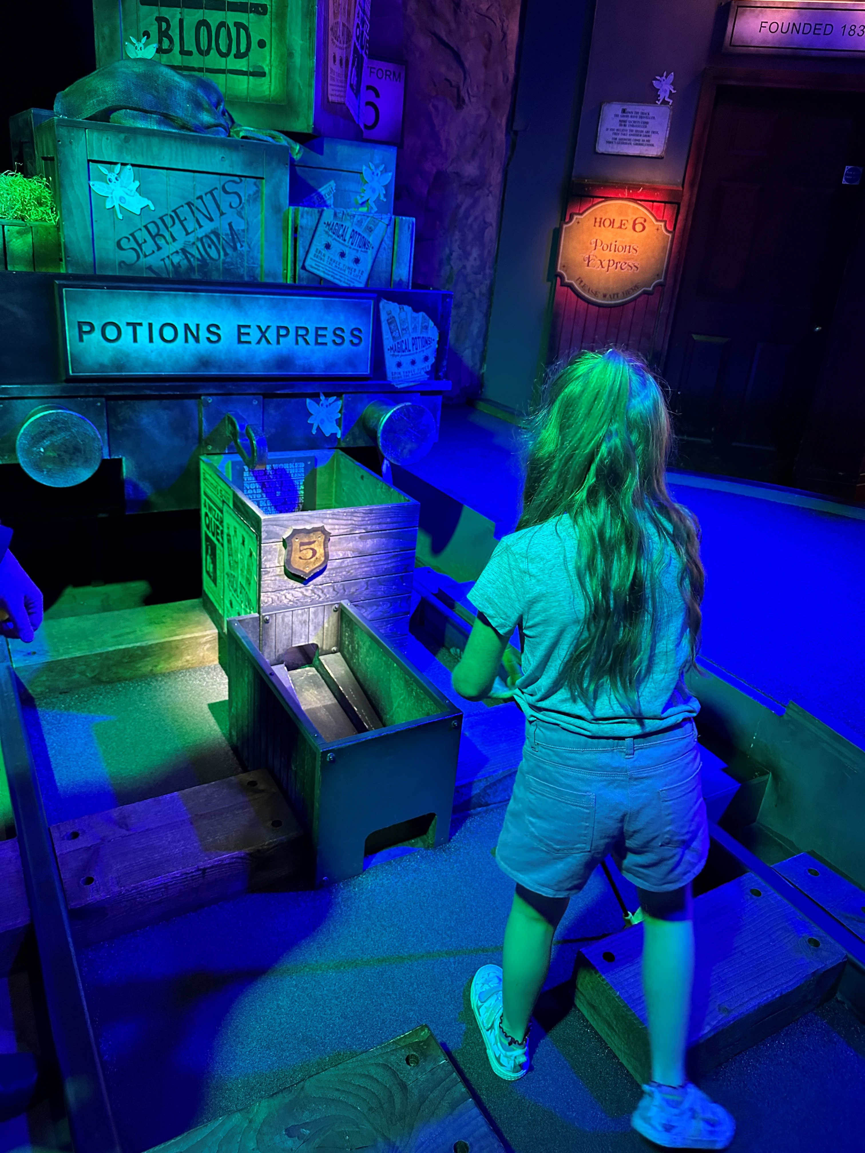 A child enjoying a wizard themed golf experience